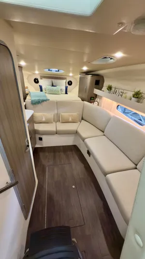  Yacht Photos Pics 2020 Regal 33 Express interior with cozy seating, modern decor, and elegant wood flooring.