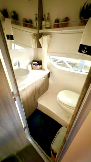  Yacht Photos Pics 2020 Regal 33 Express boat bathroom with modern fixtures and nautical decor.