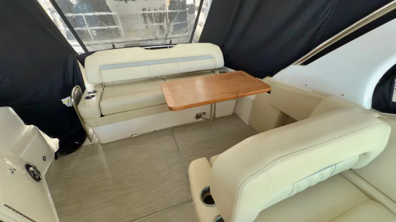  Yacht Photos Pics Interior of 2020 Regal 33 Express boat with seating and wooden table.