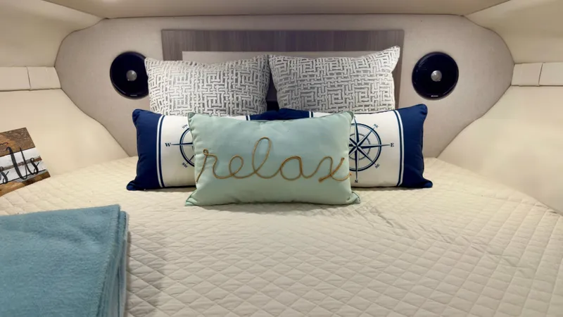  Yacht Photos Pics Cozy cabin interior of 2020 Regal 33 Express with decorative pillows and bedding.