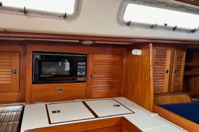 Lightwave Yacht Photos Pics Interior of 1994 J Boats J 44 sailboat with wooden cabinetry and built-in microwave.