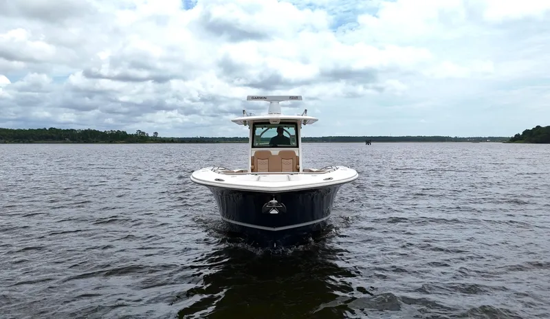 Engine Warranty X Trailer Yacht Photos Pics 2022 Scout 330 LXF boat on open water under cloudy sky.
