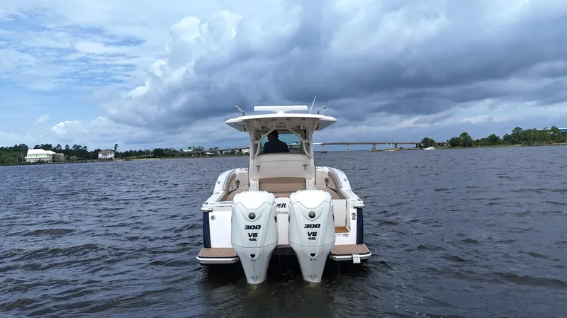 Engine Warranty X Trailer Yacht Photos Pics 2022 Scout 330 LXF boat on water with twin 300 V6 engines, cloudy sky.
