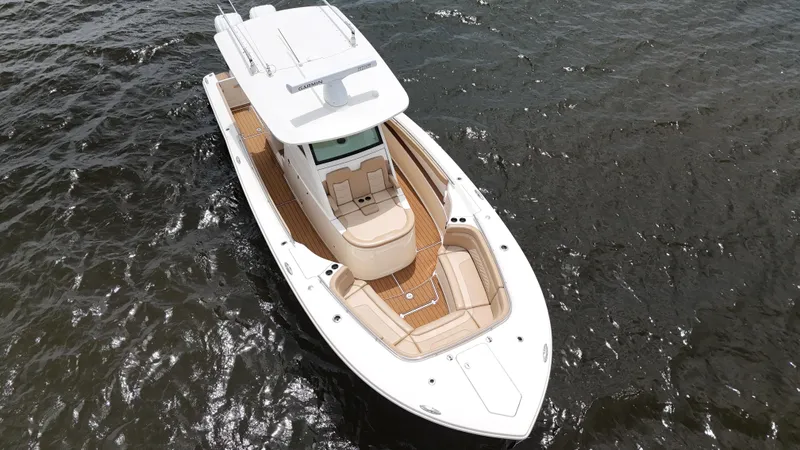 Engine Warranty X Trailer Yacht Photos Pics 2022 Scout 330 LXF boat on water, aerial view, showcasing sleek design and spacious deck.