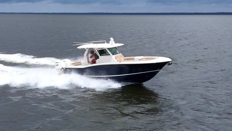 Engine Warranty X Trailer Yacht Photos Pics 2022 Scout 330 LXF boat cruising on open water.