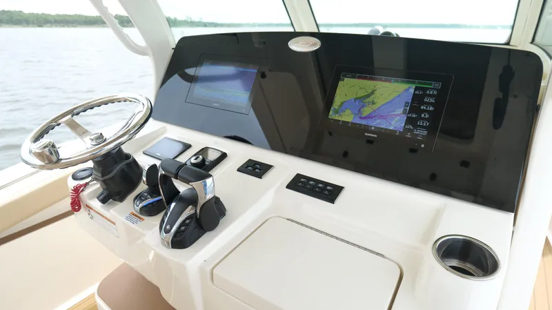 Engine Warranty X Trailer Yacht Photos Pics 2022 Scout 330 LXF helm with steering wheel, navigation screens, and controls.
