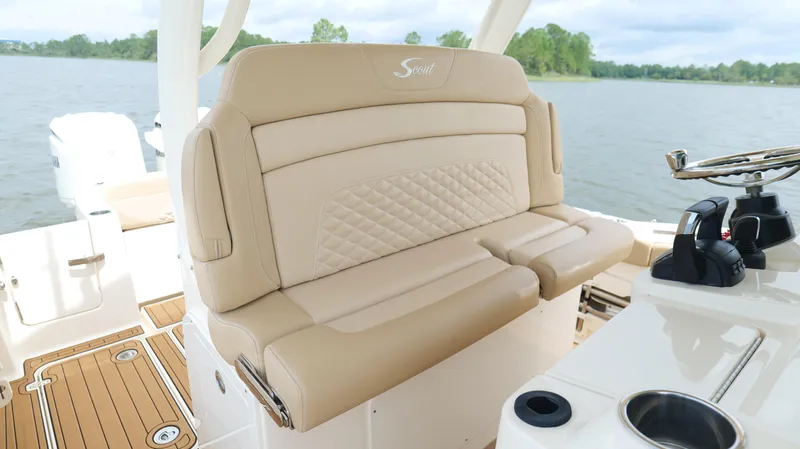 Engine Warranty X Trailer Yacht Photos Pics 2022 Scout 330 LXF boat interior with beige seating and steering wheel.