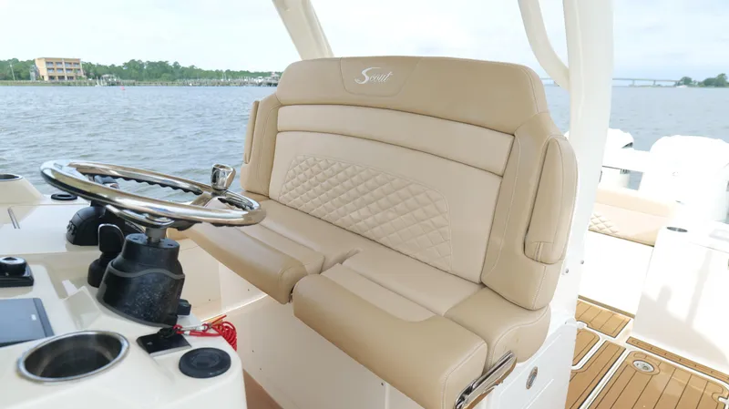 Engine Warranty X Trailer Yacht Photos Pics 2022 Scout 330 LXF boat interior with beige seating and steering wheel.