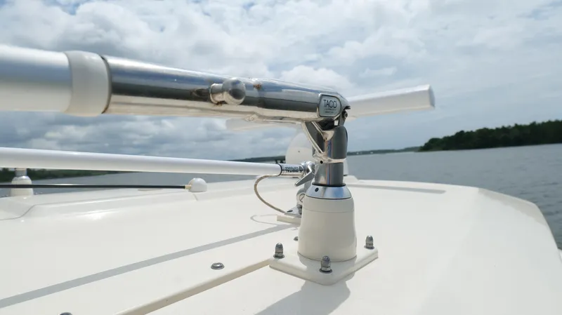 Engine Warranty X Trailer Yacht Photos Pics Close-up of 2022 Scout 330 LXF boat's metal fixture on deck, with water and sky background.