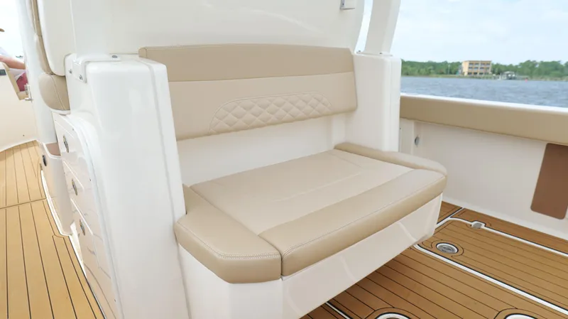 Engine Warranty X Trailer Yacht Photos Pics 2022 Scout 330 LXF boat interior with beige seating and teak flooring.