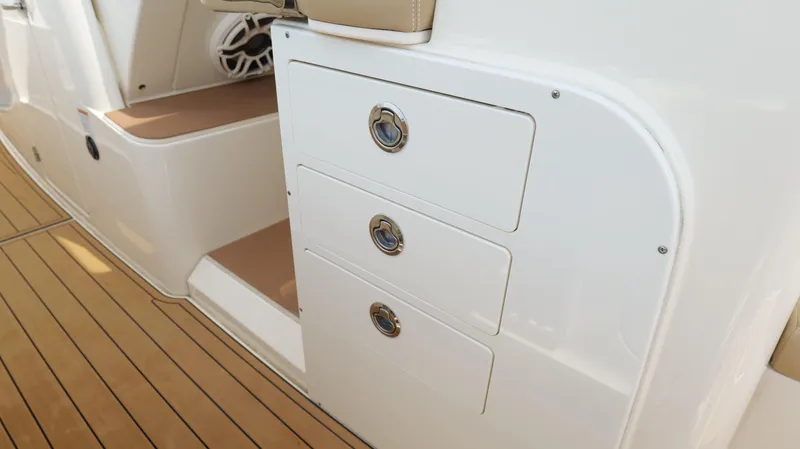 Engine Warranty X Trailer Yacht Photos Pics 2022 Scout 330 LXF boat interior with sleek storage drawers and teak flooring.