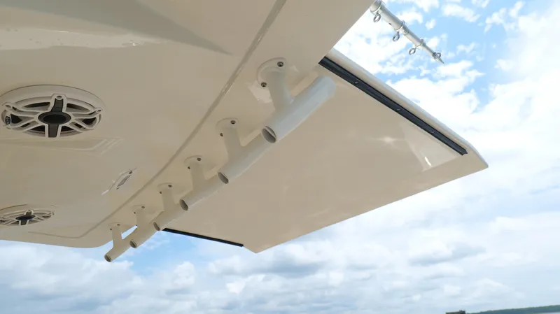 Engine Warranty X Trailer Yacht Photos Pics 2022 Scout 330 LXF boat with rod holders and speakers under a clear sky.