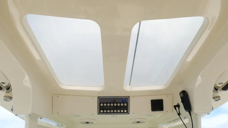 Engine Warranty X Trailer Yacht Photos Pics 2022 Scout 330 LXF boat interior with skylights and control panel.