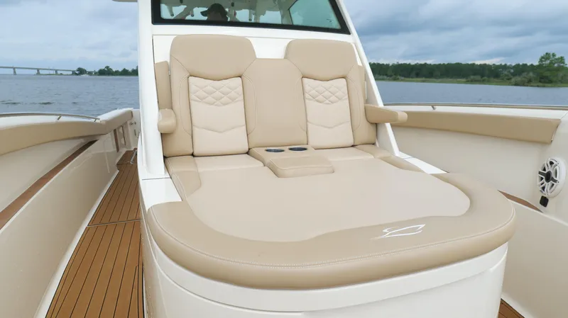 Engine Warranty X Trailer Yacht Photos Pics Luxurious seating on 2022 Scout 330 LXF boat, featuring beige upholstery and cup holders.
