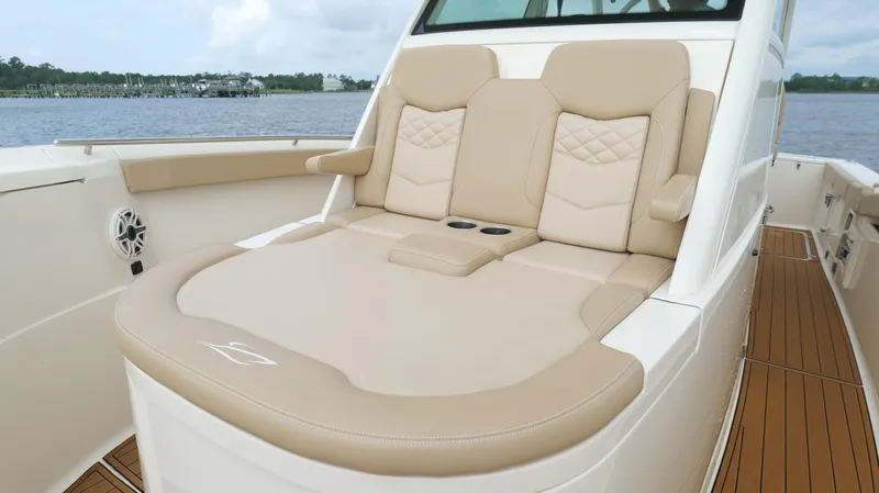 Engine Warranty X Trailer Yacht Photos Pics Luxurious seating on 2022 Scout 330 LXF boat with beige upholstery and cup holders.