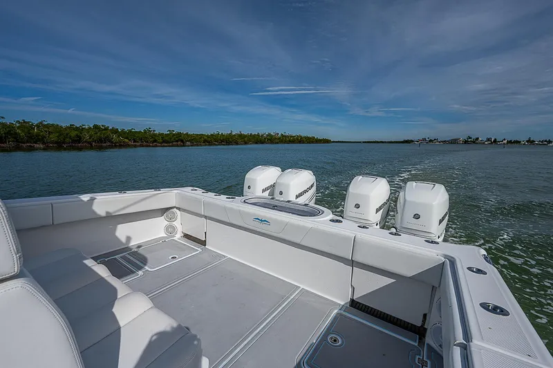 Fifty/50 Yacht Photos Pics 2019 Invincible 37 Catamaran on calm waters, showcasing powerful outboard engines.