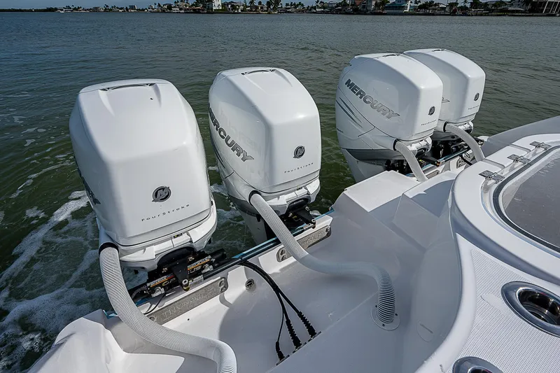 Fifty/50 Yacht Photos Pics 2019 Invincible 37 Catamaran with four Mercury outboard engines on the water.
