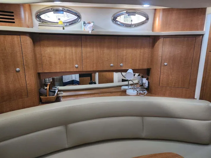 Yacht Photos Pics 2006 Sea Ray 340 Sundancer interior with wood cabinets and beige seating.