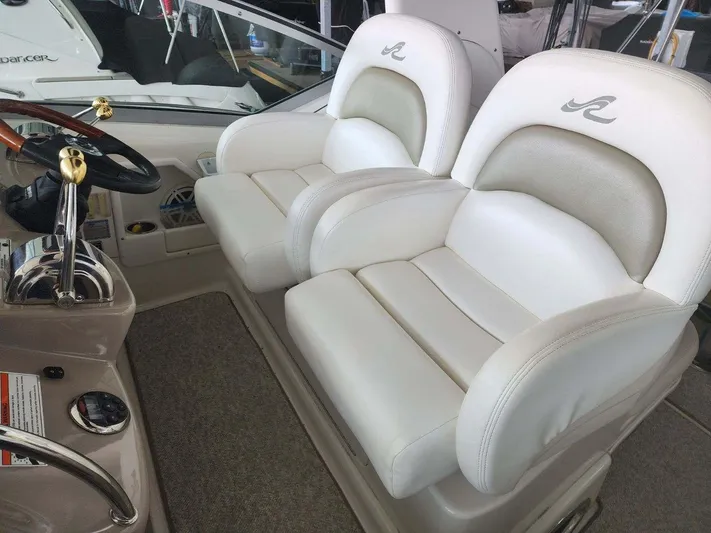  Yacht Photos Pics 2006 Sea Ray 340 Sundancer helm seats with white upholstery and logo.