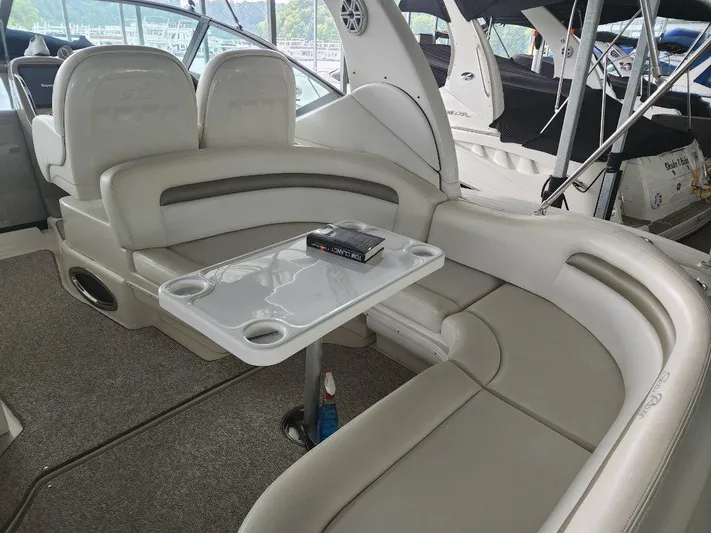  Yacht Photos Pics Interior seating area of a 2006 Sea Ray 340 Sundancer yacht with a table.