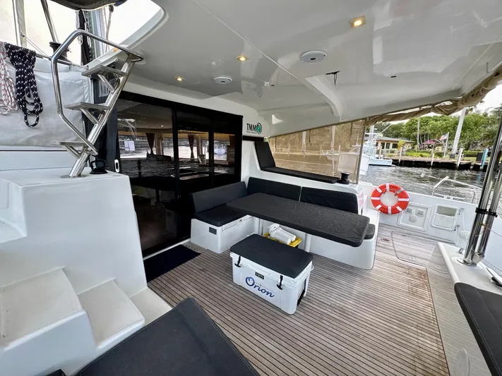 Orion Yacht Photos Pics Spacious deck of 2019 Lagoon 42 catamaran with seating and safety equipment.