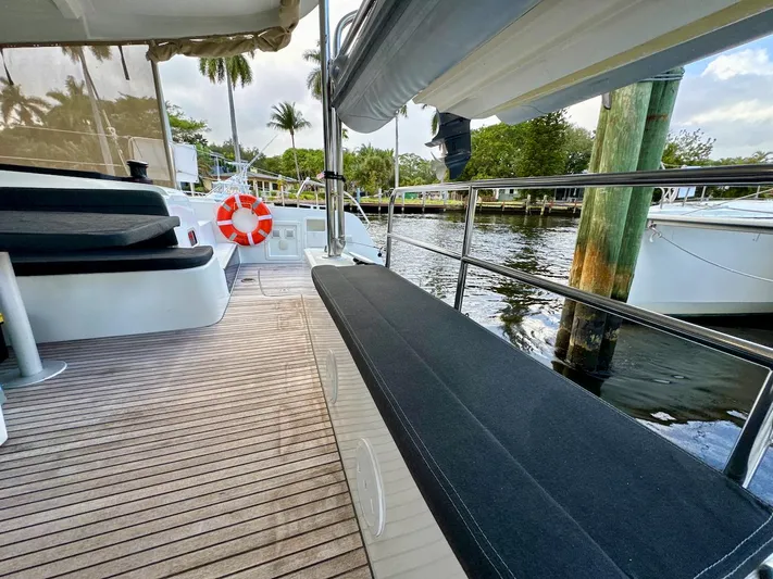 Orion Yacht Photos Pics 2019 Lagoon 42 yacht deck with seating, life preserver, and waterfront view.