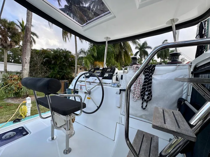 Orion Yacht Photos Pics Helm of 2019 Lagoon 42 catamaran with tropical backdrop and modern controls.