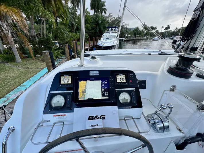 Orion Yacht Photos Pics Cockpit view of 2019 Lagoon 42 catamaran with navigation equipment and steering wheel.