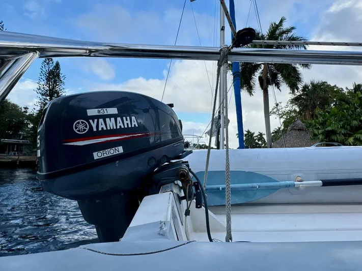 Orion Yacht Photos Pics Yamaha outboard motor on 2019 Lagoon 42 catamaran, tropical setting with palm trees.
