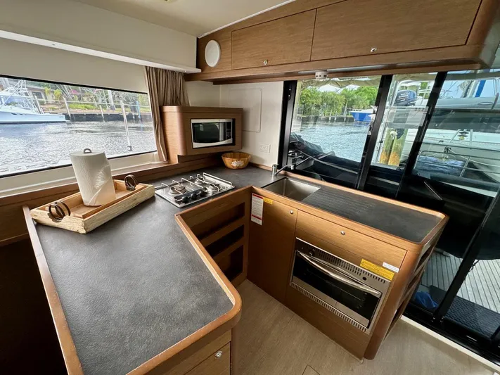 Orion Yacht Photos Pics Modern kitchen interior of 2019 Lagoon 42 catamaran with appliances and waterfront view.