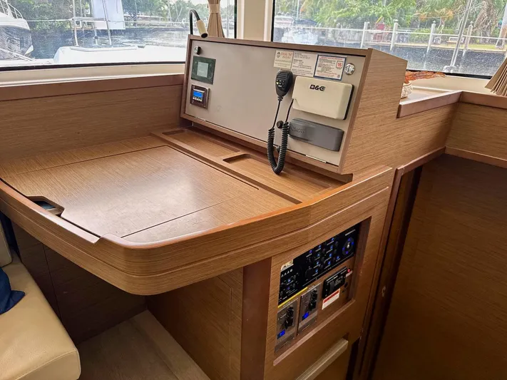 Orion Yacht Photos Pics 2019 Lagoon 42 yacht navigation station with control panel and communication equipment.