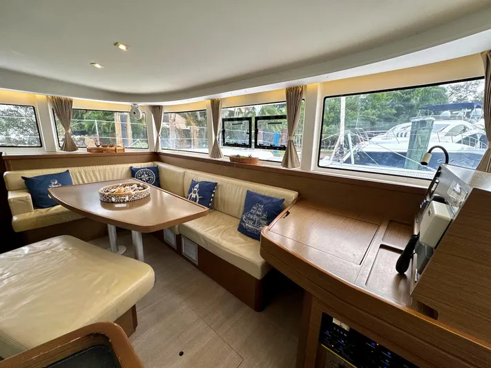 Orion Yacht Photos Pics Interior of 2019 Lagoon 42 catamaran with cozy seating and large windows.