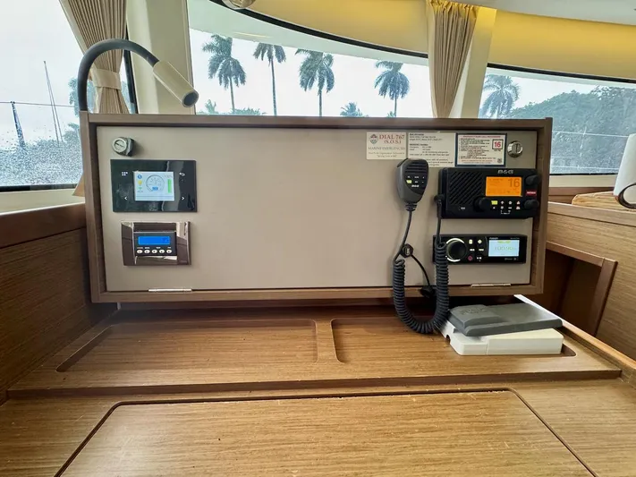 Orion Yacht Photos Pics Control panel inside a 2019 Lagoon 42 catamaran, featuring navigation and communication equipment.