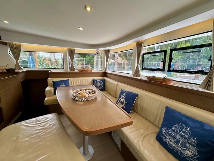 Orion Yacht Photos Pics Interior of 2019 Lagoon 42 catamaran with cozy seating and nautical decor.