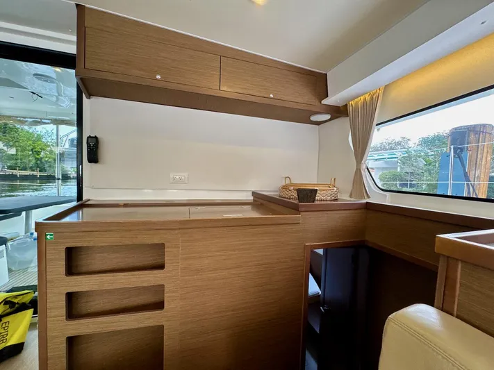Orion Yacht Photos Pics Interior of 2019 Lagoon 42 catamaran with wooden cabinetry and large window.