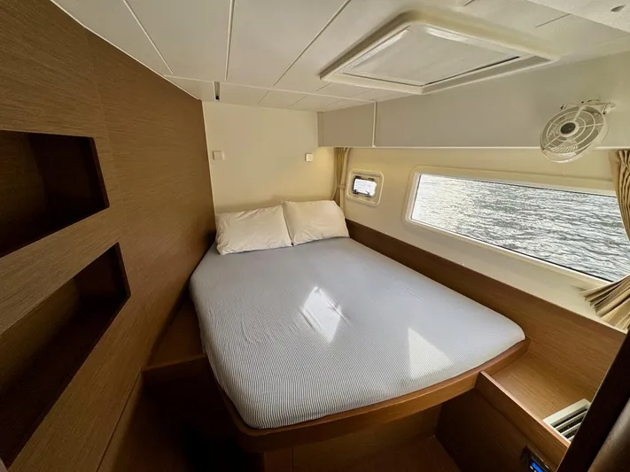 Orion Yacht Photos Pics Cozy cabin interior of 2019 Lagoon 42 catamaran with bed and window view.
