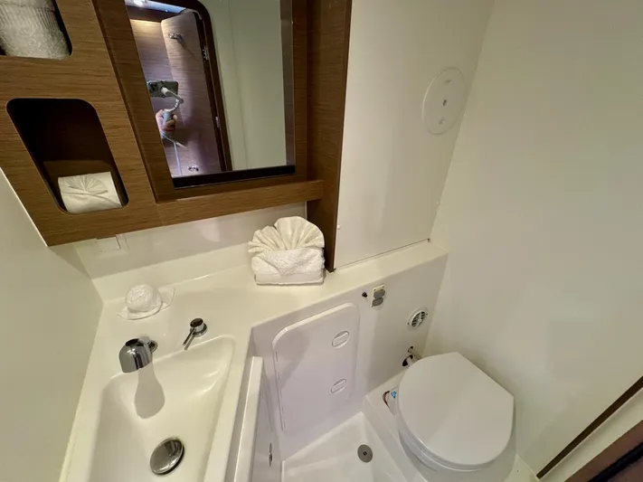 Orion Yacht Photos Pics Modern bathroom in 2019 Lagoon 42 yacht with sink, toilet, and mirror.