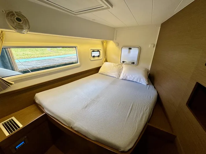 Orion Yacht Photos Pics 2019 Lagoon 42 yacht cabin with cozy bed and window view.