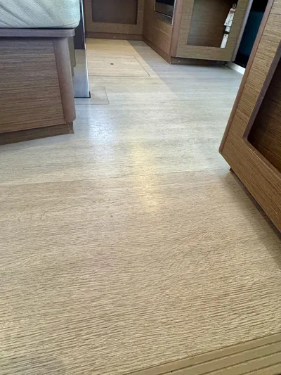 Orion Yacht Photos Pics Interior view of 2019 Lagoon 42 yacht with wooden flooring and cabinetry.