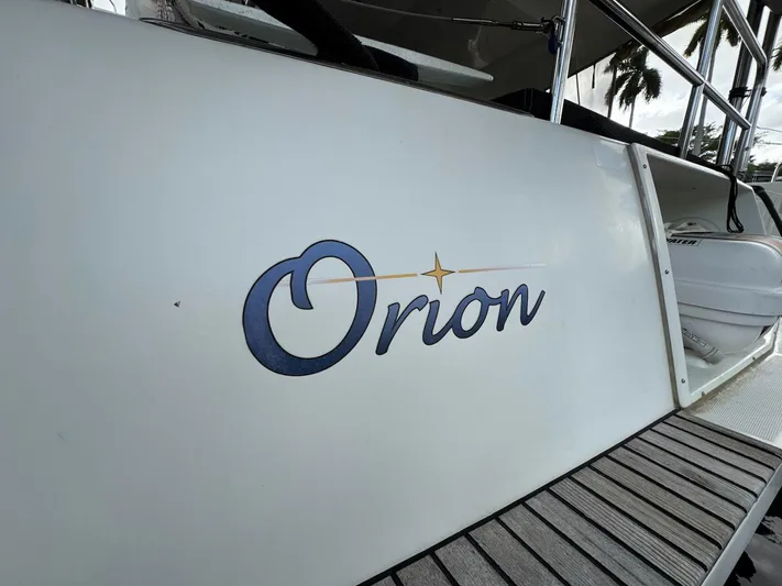 Orion Yacht Photos Pics 2019 Lagoon 42 catamaran with "Orion" name on the side, docked.