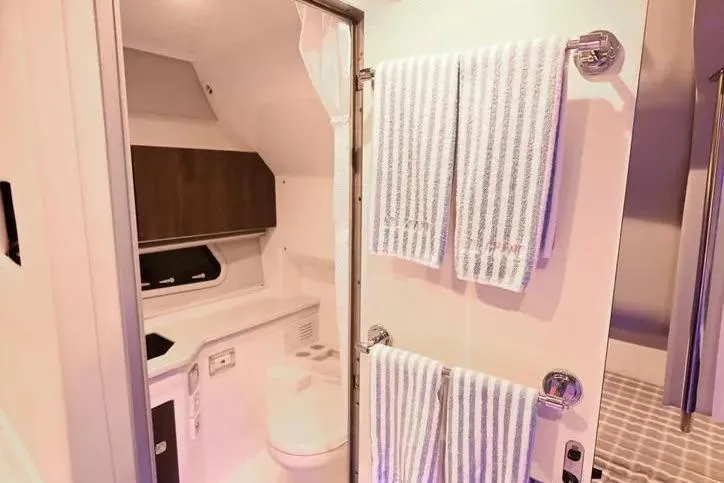  Yacht Photos Pics Interior of 2020 Formula 400 Super Sport Crossover bathroom with striped towels and modern fixtures.