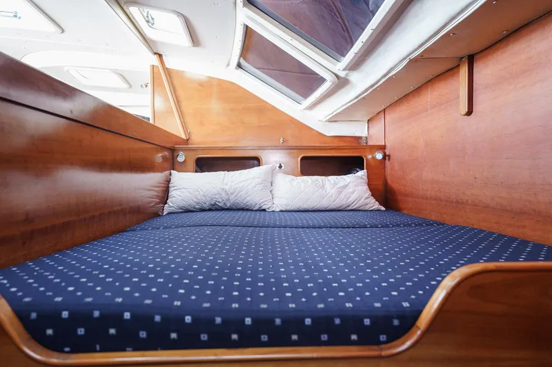 Solitude Yacht Photos Pics Cozy cabin interior of 1995 Prout 45 yacht with wooden finish and skylight.