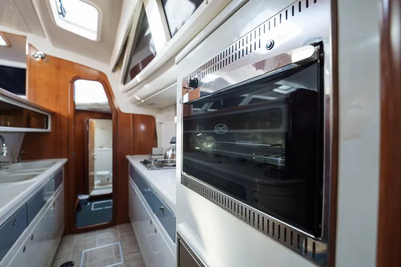 Solitude Yacht Photos Pics Interior of a 1995 Prout 45 yacht featuring a modern kitchen area.