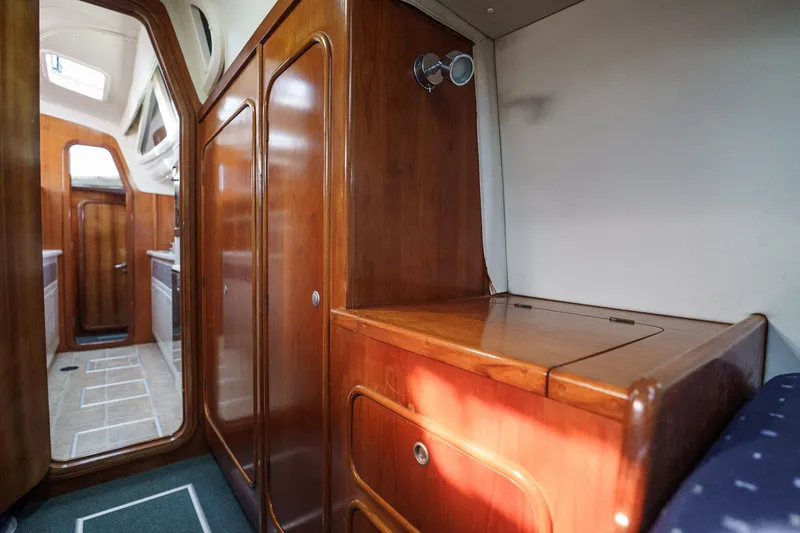 Solitude Yacht Photos Pics Interior of a 1995 Prout 45 yacht featuring wooden cabinetry and compact design.