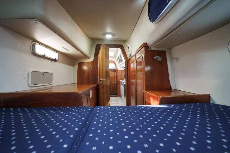 Solitude Yacht Photos Pics Interior of 1995 Prout 45 yacht with wooden cabinetry and blue polka dot bedding.