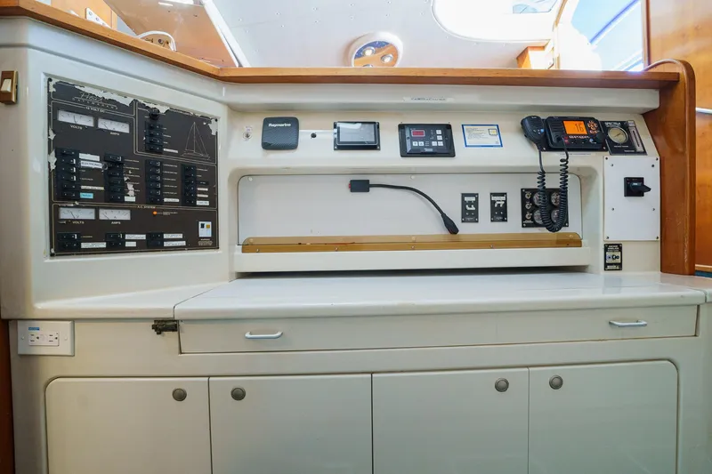 Solitude Yacht Photos Pics Navigation station on a 1995 Prout 45 yacht with control panels and communication equipment.