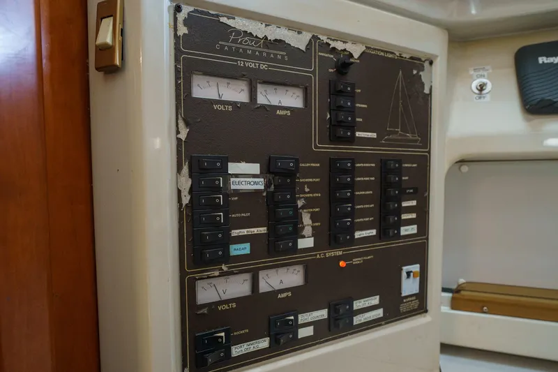 Solitude Yacht Photos Pics Electrical control panel on a 1995 Prout 45 boat, featuring volt and amp meters.