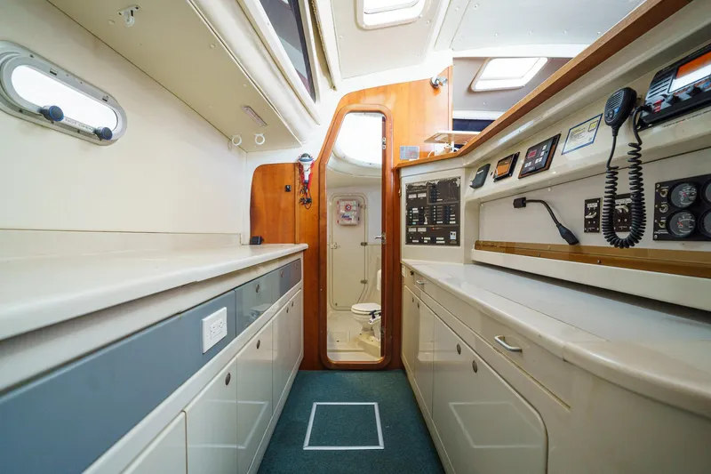 Solitude Yacht Photos Pics Interior of a 1995 Prout 45 yacht, featuring a modern navigation station and compact bathroom.