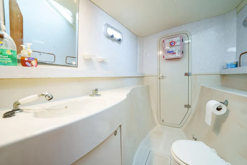 Solitude Yacht Photos Pics Bathroom interior of a 1995 Prout 45 yacht, featuring sink, mirror, and toilet.