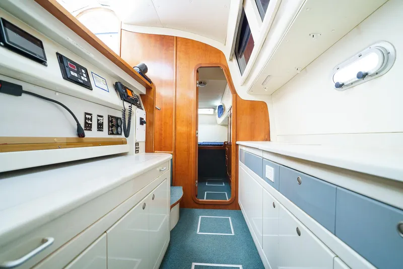 Solitude Yacht Photos Pics Interior of a 1995 Prout 45 yacht, featuring modern navigation equipment and sleek cabinetry.